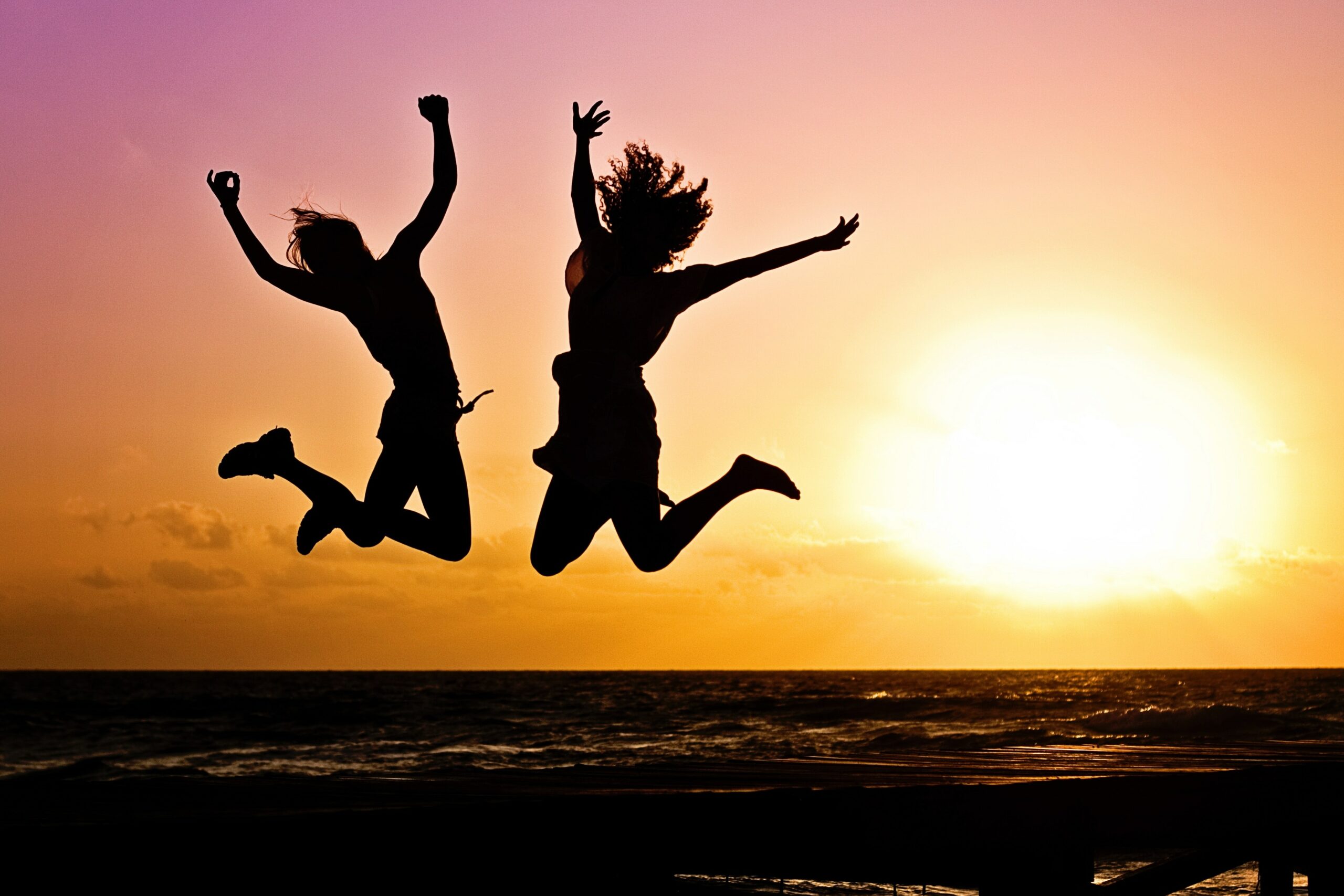 two people jumping and celebrating a victory